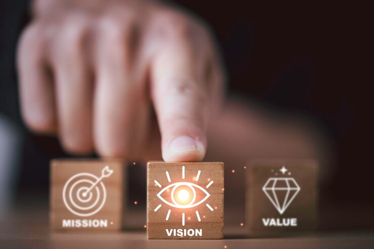 businessman pointing glowing wooden block with vision icon representing mission strategy company value leadership goal management business growth inspiration 50039 6536